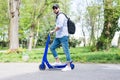 Man using blue electric scooter in the park