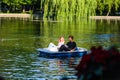 Bucharest, Romania - 2019. Portrait of young couple in love talking while pedal boating on the lake. Cheerful man and woman Royalty Free Stock Photo