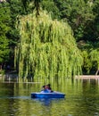 Bucharest, Romania - 2019. Portrait of young couple in love talking while pedal boating on the lake. Cheerful man and woman Royalty Free Stock Photo