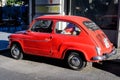 Bucharest, Romania, 25 September 2021: One vivid red small Fiat vintage car parked in a street in the city center Royalty Free Stock Photo