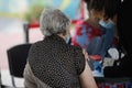 A senior woman is preparing to get the third dose of Pfizer Biontech anti Covid-19 vaccine in a mobile vaccination centre Royalty Free Stock Photo