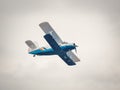 A soviet Antonov An-2 single-engine biplane flying against blue sky