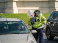 Bucharest/Romania - 10.17.2020: Traffic police officer writing a ticket to a female driver who broke the law Royalty Free Stock Photo