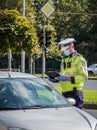 Bucharest/Romania - 10.17.2020:Traffic police officer writing a ticket to a female driver who broke the law Royalty Free Stock Photo