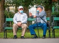 Bucharest/Romania - 05.23.2020: Two old man sitting on a bench in the park and talking Royalty Free Stock Photo