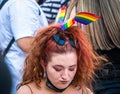 Woman wearing the The rainbow flag, symbol of LGBT and queer pride in her hair at LGBTQ Pride