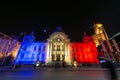 Bucharest spot light festival CEC historical building with hologram of Romanian national flag