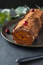 Buche de Noel. Traditional Christmas dessert, Christmas yule log cake with chocolate cream, cranberry. Copy space. Royalty Free Stock Photo