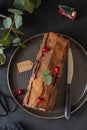 Buche de Noel. Traditional Christmas dessert, Christmas yule log cake with chocolate cream, cranberry. Copy space. Royalty Free Stock Photo