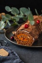 Buche de Noel. Traditional Christmas dessert, Christmas yule log cake with chocolate cream, cranberry. Copy space. Royalty Free Stock Photo