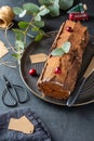 Buche de Noel. Traditional Christmas dessert, Christmas yule log cake with chocolate cream, cranberry. Copy space. Royalty Free Stock Photo