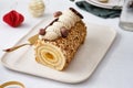 Buche de Noel. Traditional Christmas dessert, Christmas yule log cake with vanilla cream. Christmas tree branches.