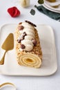 Buche de Noel. Traditional Christmas dessert, Christmas yule log cake with vanilla cream. Christmas tree branches. Royalty Free Stock Photo