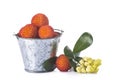 Bucket with arbutus unedo fruits over white Royalty Free Stock Photo