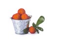 Bucket with arbutus unedo fruits over white Royalty Free Stock Photo