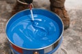 Bucket of blue paint mixing on motion Royalty Free Stock Photo