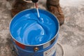 Bucket of blue paint mixing on motion Royalty Free Stock Photo