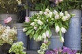 The bucket with a bouquet of white tulips and a vase with red roses as a decoration for the entrance of the house Royalty Free Stock Photo