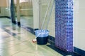 Bucket and brush for cleaning floors in the room standing