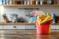 Bucket with cleaning items on wooden table