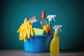 Bucket with cleaning products on the table on a blue background Royalty Free Stock Photo