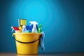 Bucket with cleaning products on the table on a blue background Royalty Free Stock Photo