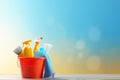 Bucket with cleaning products on the table on a blue background Royalty Free Stock Photo