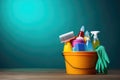 Bucket with cleaning products on the table on a blue background Royalty Free Stock Photo