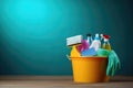 Bucket with cleaning products on the table on a blue background Royalty Free Stock Photo