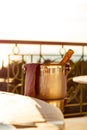 Bucket of cold champagne, on the table, in a summer restaurant Royalty Free Stock Photo