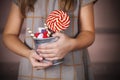 Bucket with colorful candies in the hands of little girl Royalty Free Stock Photo