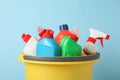 Bucket with detergent and cleaning supplies on blue background Royalty Free Stock Photo