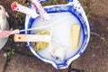 A bucket with dirty brushes and rollers for whitewashing Royalty Free Stock Photo