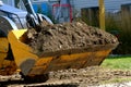 Excavating bucket full of dirt