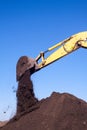 Bucket of an excavator against mountain and sky