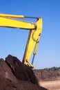 Bucket of an excavator against mountain and sky