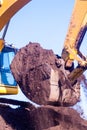 Bucket of an excavator against mountain and sky