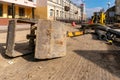 The bucket from the excavator lies on the construction site. Repair of asphalt on the roadway in the city. Removal of the old Royalty Free Stock Photo