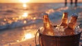 A bucket filled with icecold beers ready to be cracked open and enjoyed during a sunset picnic on the beach