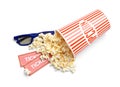 Bucket of fresh popcorn, tickets and 3D glasses on white, top view. Cinema snack