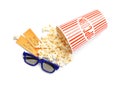 Bucket of fresh popcorn, tickets and 3D glasses on background, top view. Cinema snack Royalty Free Stock Photo
