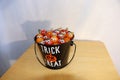 A bucket full of small tomatoes with googly eyes are treats for Halloween.