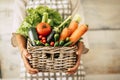 Bucket full of vegetables and unrecgnizable woman holding and showing it - home healthy kitchen and cookin lifestyle for diet or