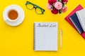 Bucket list. Blank notebook to write goals and wishes on yellow office desk top-down Royalty Free Stock Photo