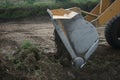 Bucket Loader dumping a load of dirt in road construction