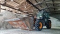 Bucket loader JCB in a warehouse of mineral organic fertilizers