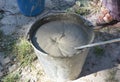 A bucket with mixed cement mortar on the construction for laying bricks