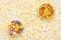 bucket of nachos and sweet, colorful popcorn, on the background of scattered flakes