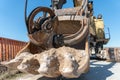 The bucket of an old quarry excavator is a close-up. The crawler excavator is located on the territory of a mining quarry. an open Royalty Free Stock Photo