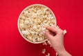 Bucket of popcorn on red background, top view Royalty Free Stock Photo